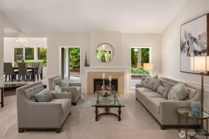 The formal living room provides an elegant gathering space, complete with a cozy fireplace and serene golf course views. From the moment you enter, soaring vaulted ceilings and expansive picture windows fill the home with natural light and create a seamless connection to the surrounding landscape. The formal living room provides an elegant gathering space, complete with a cozy fireplace and serene golf course views. From the moment you enter, soaring vaulted ceilings and expansive picture windows fill the home with natural light and create a seamless connection to the surrounding landscape.