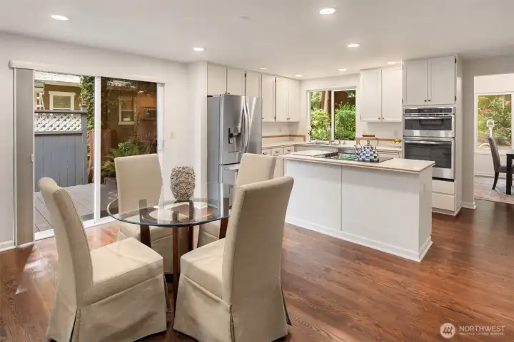 The open kitchen features a center island with a cooktop, stainless steel appliances, and a generous walk-in pantry. The open kitchen features a center island with a cooktop, stainless steel appliances, and a generous walk-in pantry.