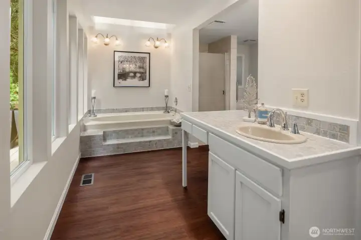 The ensuite bath features a soaking tub with tranquil garden views, dual vanities, and walk-in closets. The ensuite bath features a soaking tub with tranquil garden views, dual vanities, and walk-in closets.