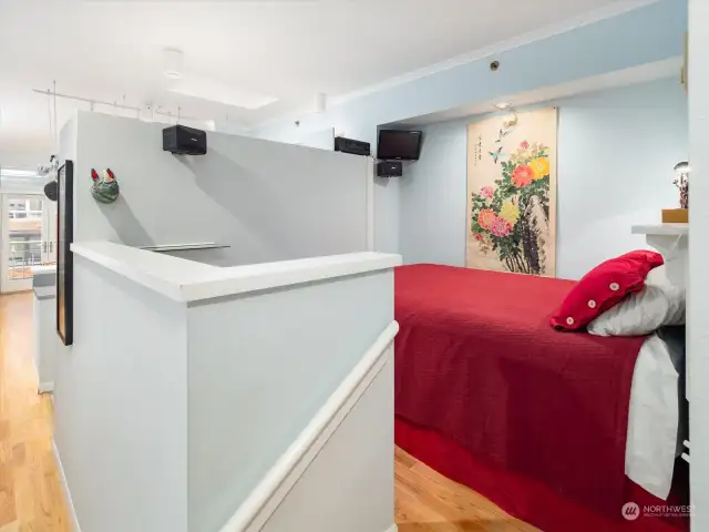 The sleeping area is elevated. The owner put in a built-in head board that could be removed so the bed could be put against any of the three walls