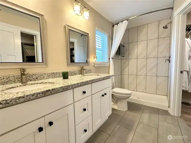 Primary bath with double sinks and two walk in closets