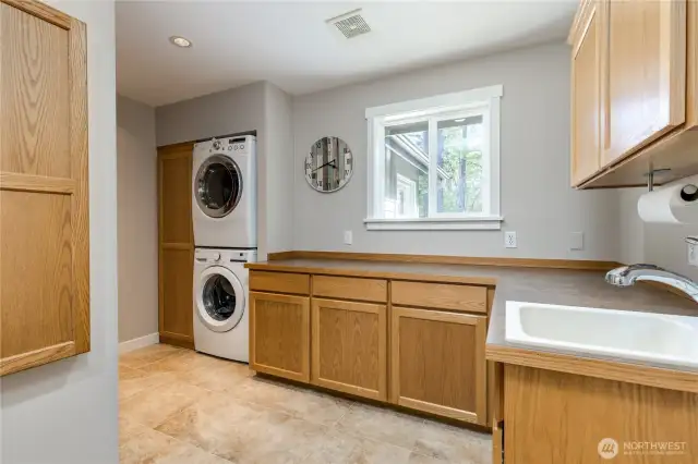 Laundry room has lots of storage and fold-down ironing board