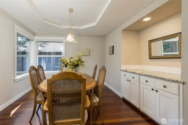 Formal dining room with tray ceiling and built-in cabinets