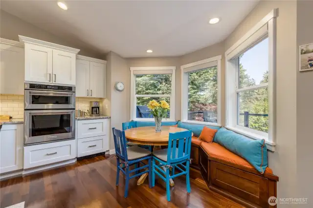 Cozy breakfast nook. The drawers next to the oven are a convenient beverage fridge!