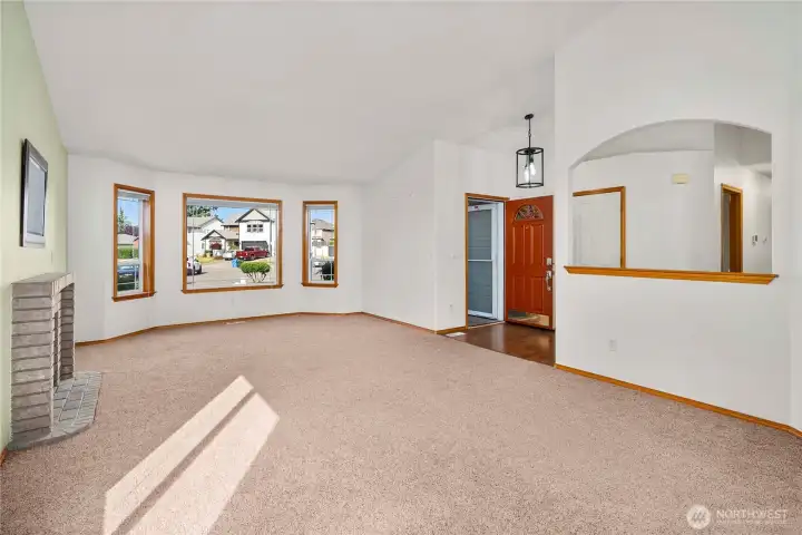 Vaulted ceilings and natural light pouring thru the large windows gives this formal living room a very open feeling!