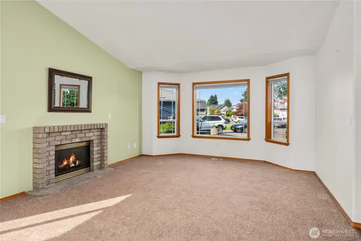 Cozy gas fireplace with a brick surround a perfect place to relax.