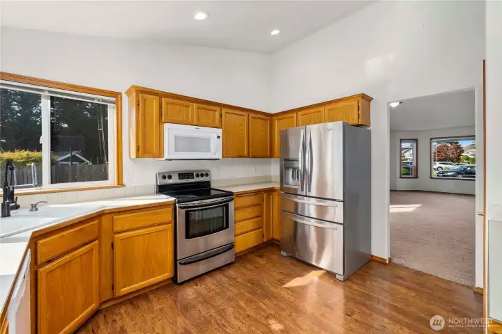 Laminate hardwood flooring in kitchen, entry way and down hall way.