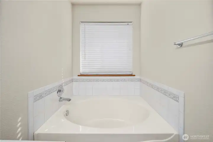Soaking tub in the primary bedroom
