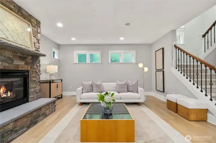 Living room with a cozy fireplace and privacy glass windows