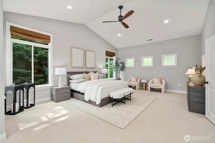 The primary suite impresses with generous proportions and vaulted ceilings, offering both openness and elegance.