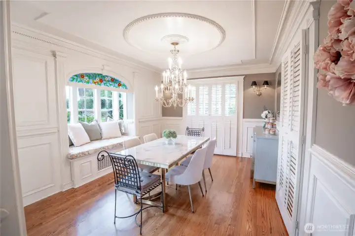 A bay window kickout with pillow seating adds charm to this light-filled space.