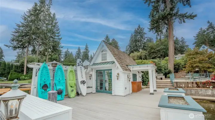 Boathouse with a propane fireplace, kitchenette, serving bar with doors that swing open to the exterior serving bar.