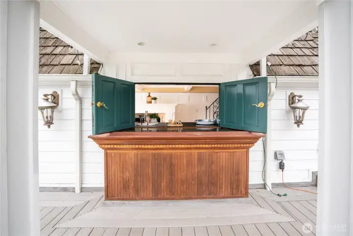 The exterior bar with doors that open to the interior kitchenette.