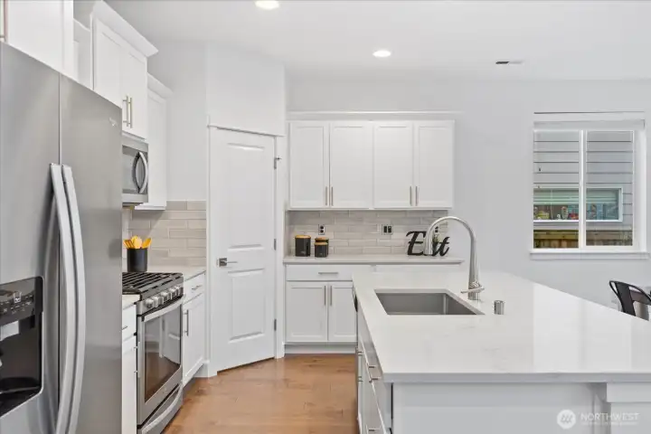 Walk-in pantry provides ample kitchen storage.