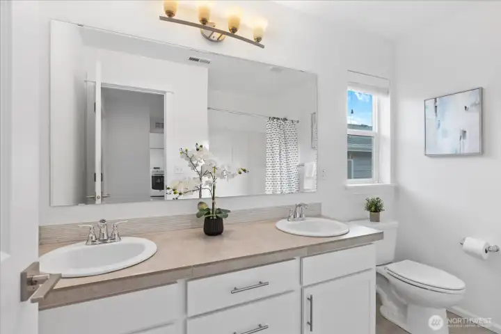 Upstairs full bathroom with dual vanities.
