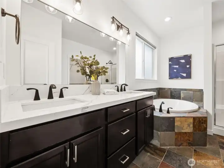Primary bathroom has duel sink, all updated with new quartz counters, lighting fixtures & faucets.