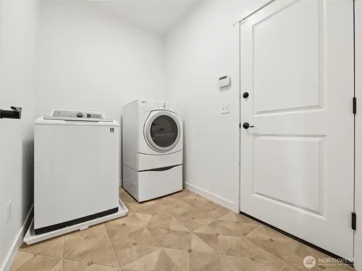 Clean and efficient laundry room leads to the oversized, 2-car garage.