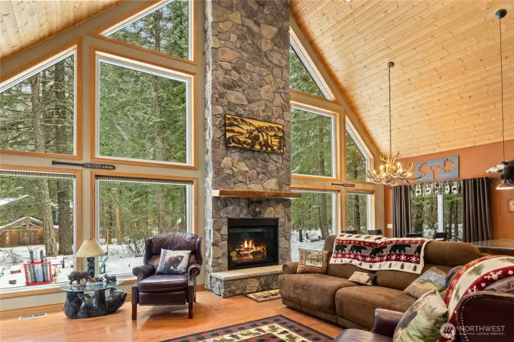 Vaulted wood wrapped ceilings with striking floor to ceiling stone fireplace!