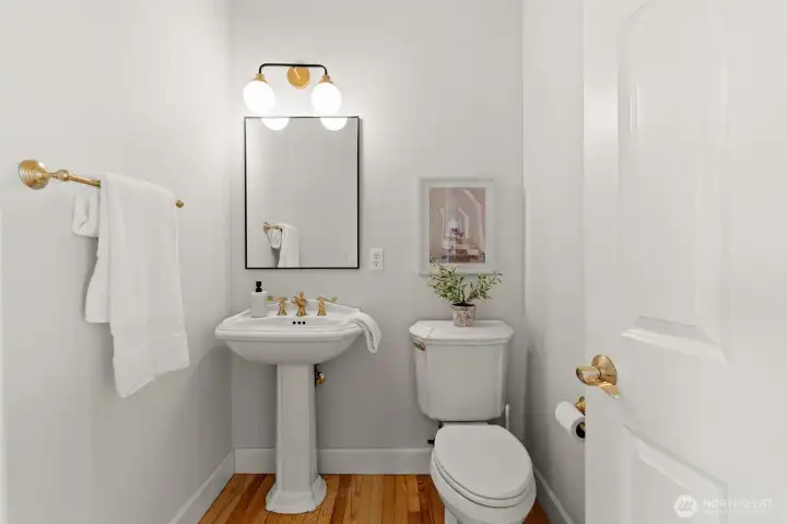 Main-level powder room conveniently located for guests and everyday use. Main-level powder room conveniently located for guests and everyday use.