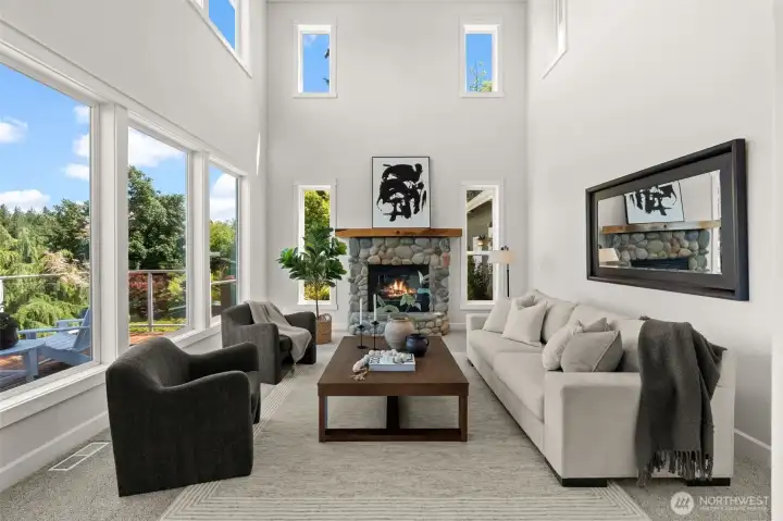 Expansive living area with dramatic ceiling height and large windows overlooking the deck. Expansive living area with dramatic ceiling height and large windows overlooking the deck.