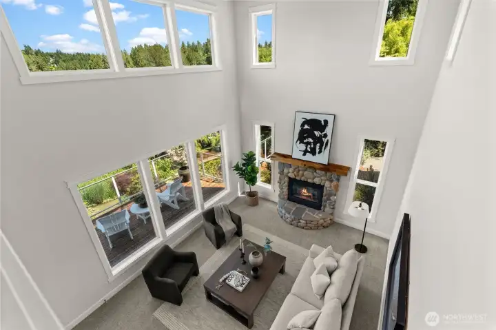 Bird's-eye view of the great room highlights the spacious layout, fireplace, and wall of windows. Bird's-eye view of the great room highlights the spacious layout, fireplace, and wall of windows.