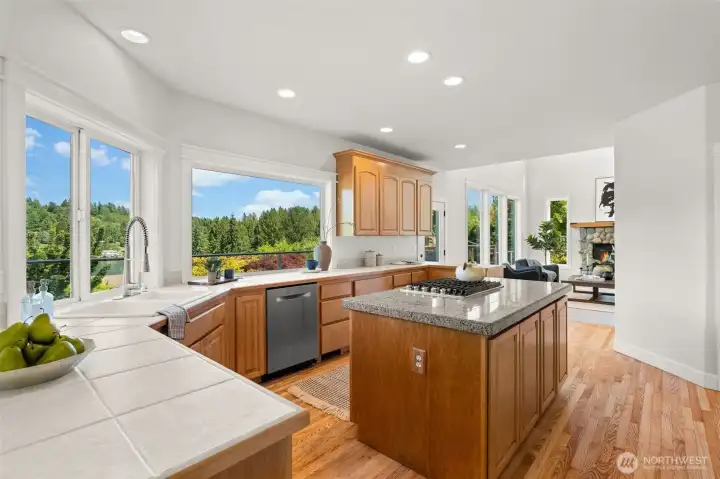 Spacious kitchen with island seating, ample cabinetry, and views extending toward the water. Spacious kitchen with island seating, ample cabinetry, and views extending toward the water.