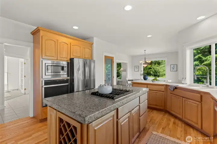 Gather with ease in this spacious kitchen featuring a large center island, abundant cabinetry, and an open layout connecting to the dining and living areas. Gather with ease in this spacious kitchen featuring a large center island, abundant cabinetry, and an open layout connecting to the dining and living areas.