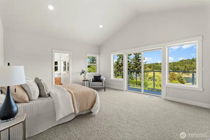 Welcoming primary suite features deck. access, water views, and an adjoining en suite bath, creating a peaceful retreat within the home. Welcoming primary suite features deck. access, water views, and an adjoining en suite bath, creating a peaceful retreat within the home.