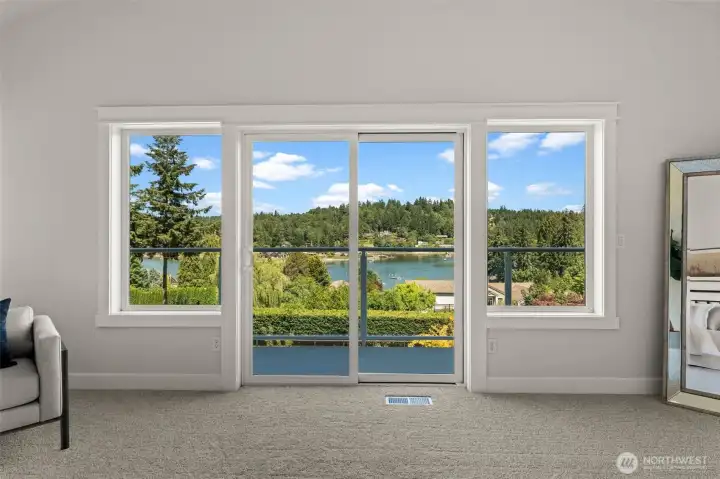 Wake up to water views and direct deck access from the primary suite, enhancing the home's connection to the outdoors. Wake up to water views and direct deck access from the primary suite, enhancing the home's connection to the outdoors.