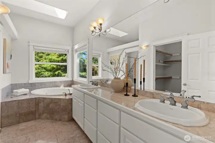 Primary bathroom features dual vanities, a soaking tub, and convenient access to the walk-in closet. Primary bathroom features dual vanities, a soaking tub, and convenient access to the walk-in closet.
