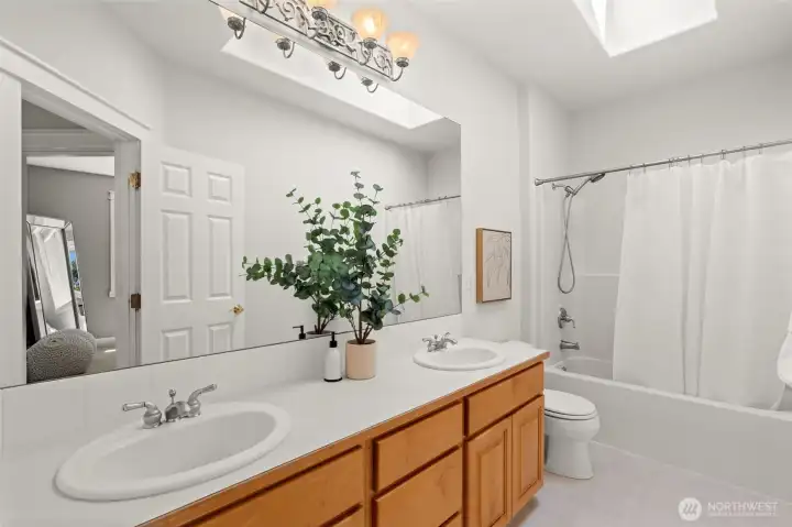 Bathroom includes a large vanity, expansive mirror, and tub/shower combination. Bathroom includes a large vanity, expansive mirror, and tub/shower combination.