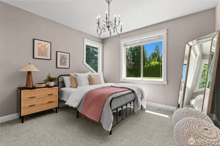 Comfortable bedroom features generous floor space and abundant natural light. Comfortable bedroom features generous floor space and abundant natural light.