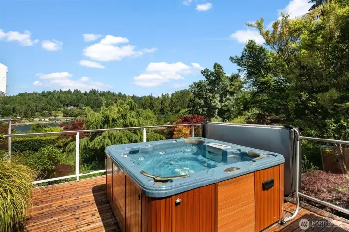 Private deck provides space for outdoor relaxation with a hot tub and views beyond. Private deck provides space for outdoor relaxation with a hot tub and views beyond.