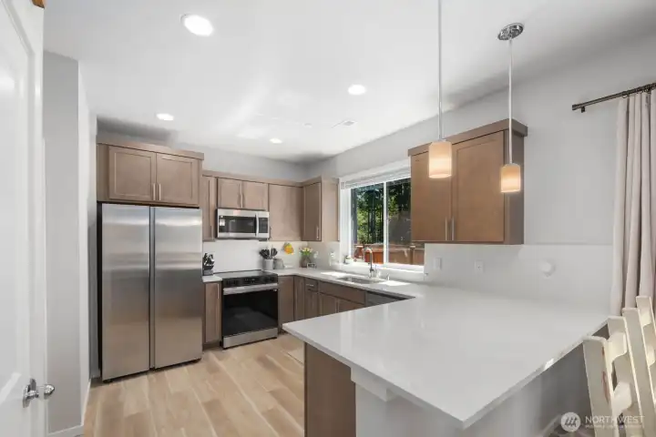 Kitchen featuring a center island, stainless steel appliances, and ample cabinet and counter space.