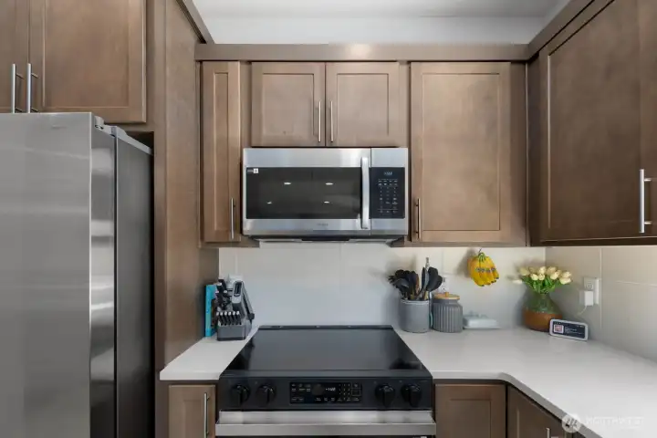 Additional kitchen view highlighting the appliance layout, storage, and preparation space.