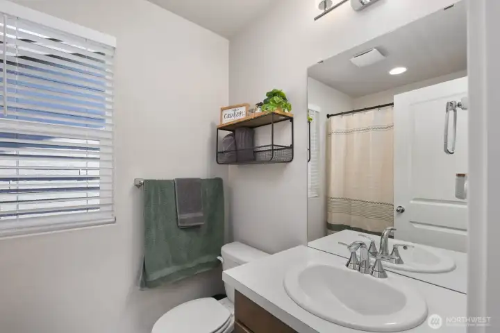 Bathroom with a vanity, mirror, and tub/shower combination.