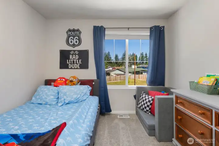Additional bedroom view showcasing the room layout, window placement, and natural light.