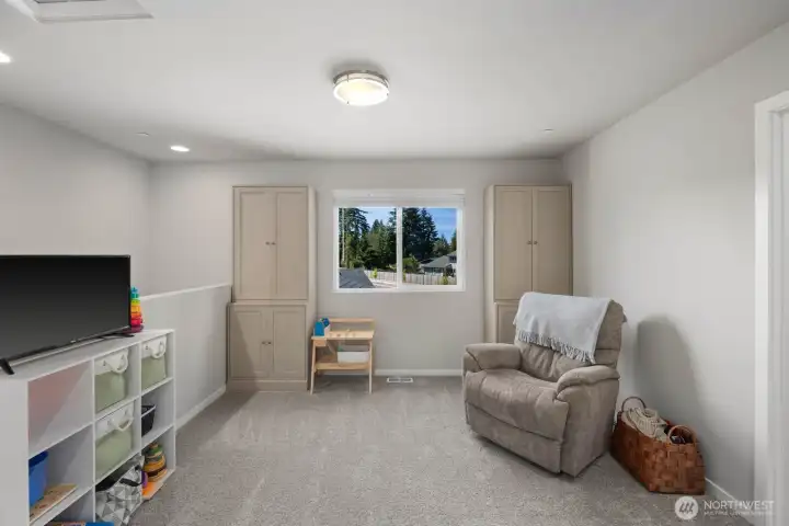 Additional view of the flexible living space highlighting the open layout and window placement.