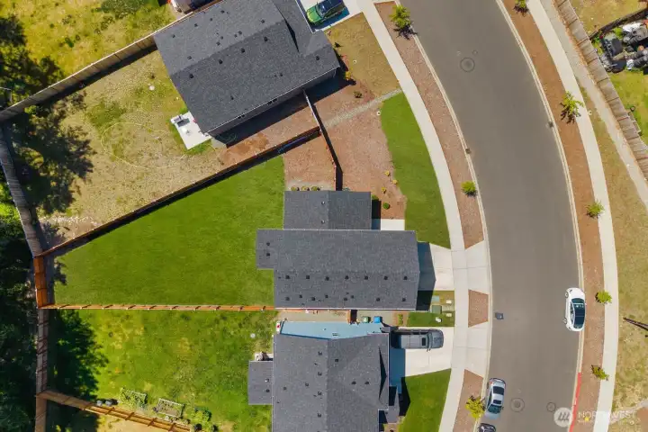 Aerial view highlighting the home's position on the lot, backyard size, and surrounding property boundaries.