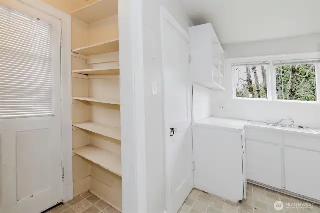 Storage shelves by side door.