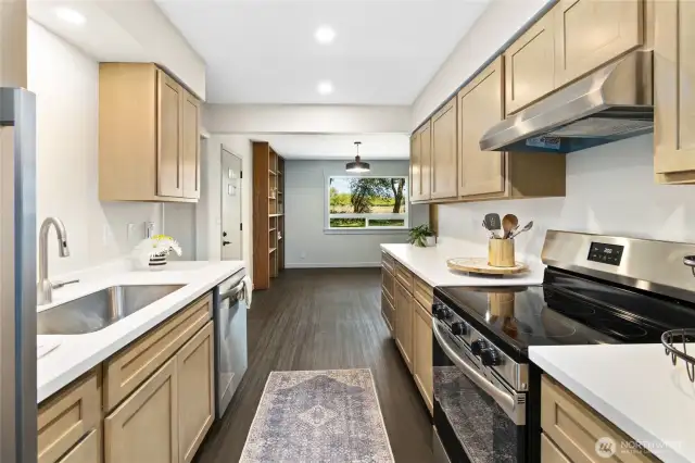 The kitchen is all new with beautiful cabinetry and solid surface countertops!