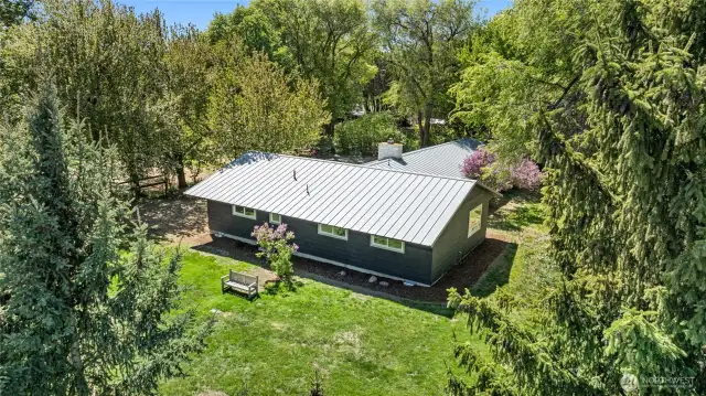 Metal roof and mature landscaping