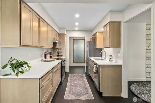 The kitchen is all new with beautiful cabinetry and solid surface countertops!