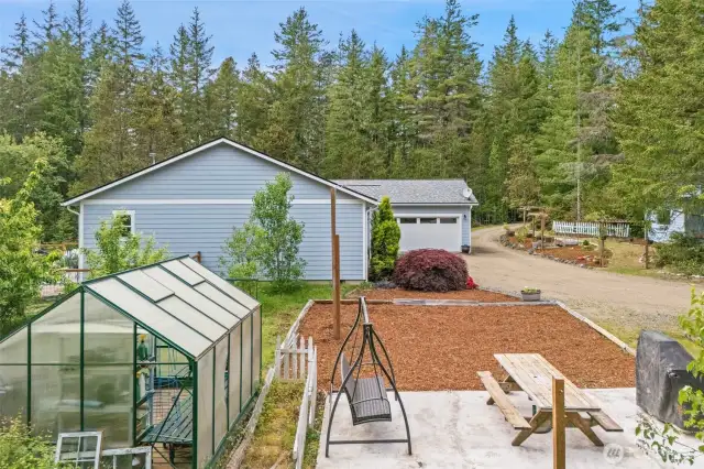 Green house is close to the house for easy access.