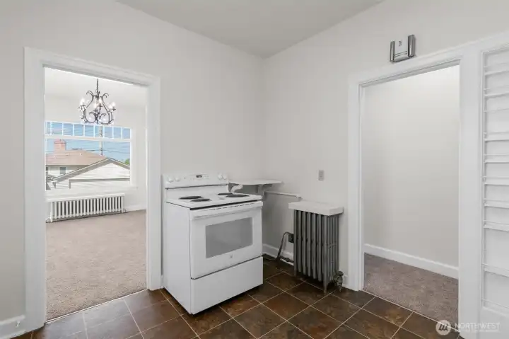 Upper-level kitchen opens to the formal dining room.