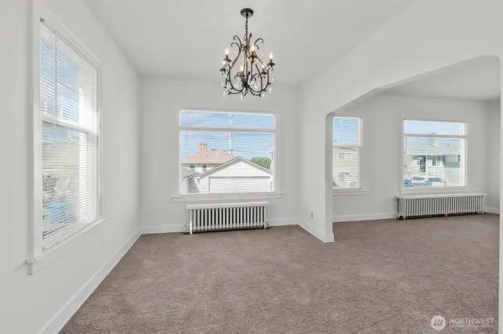 Upper-level dining area with living room to the right.
