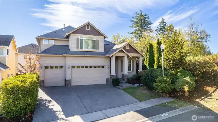 This beautiful two-story home sits proudly on a quiet dead-end corner lot, offering curb appeal and privacy. The three-car garage, tall front columns, and detailed trim highlight the craftsman-inspired design. Surrounded by mature landscaping and a peaceful setting, this home blends elegance and Northwest comfort seamlessly.