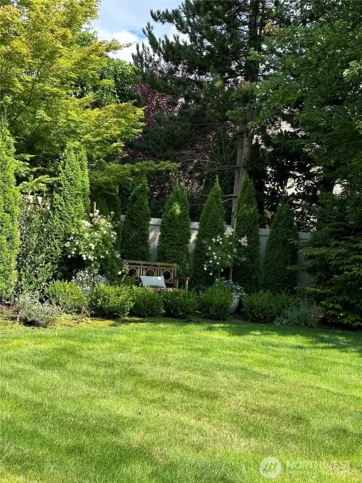 Tons of mature planting and trees making a fully private backyard.
