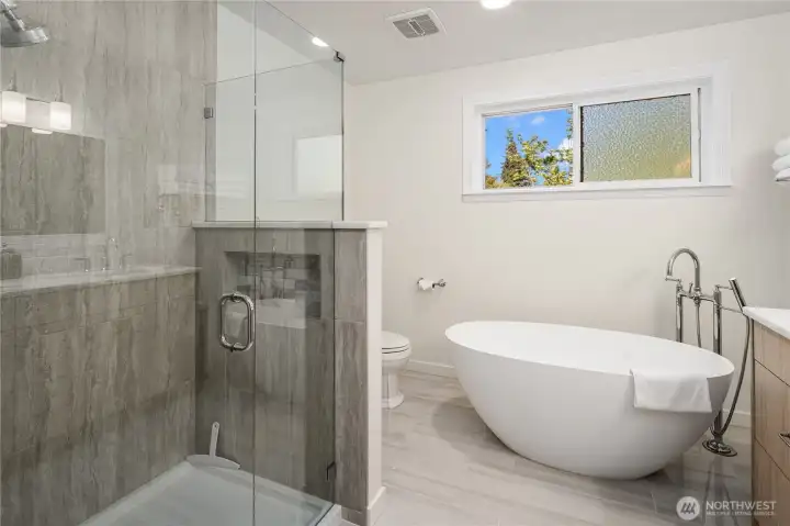 Walk-in shower is super nice with glass doors.