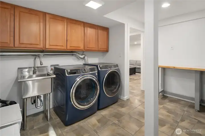 Great laundry area, laundry sink, and folding area.